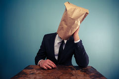 sad-businessman-bag-over-his-head-37556904